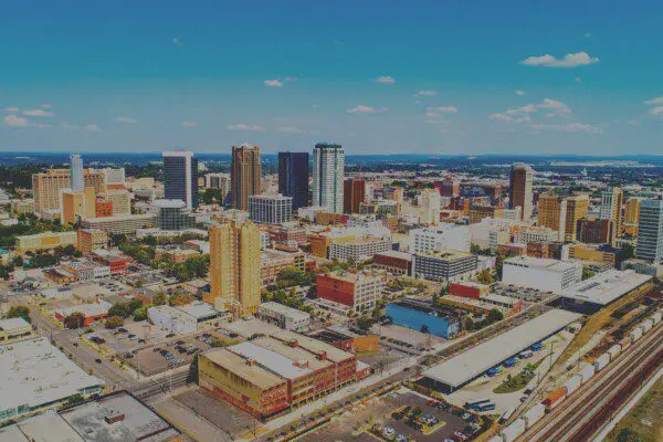 Birmingham, Alabama downtown skyline with train track and passing train.